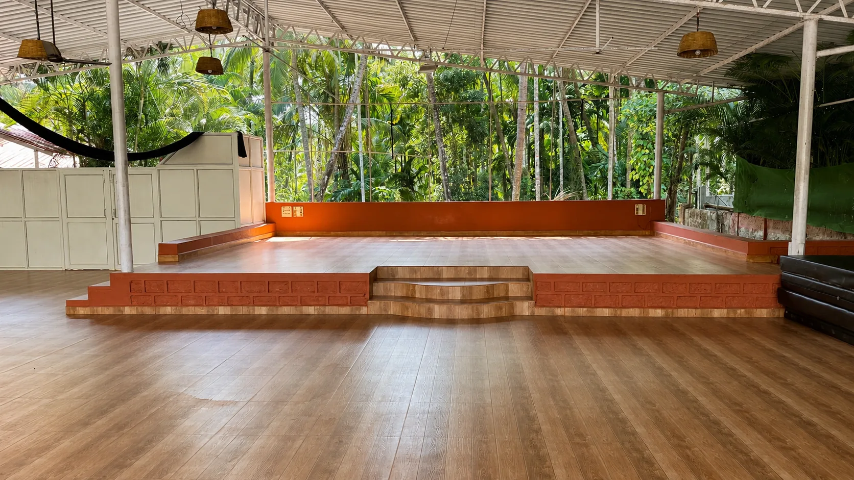 The open-air shala with a raised stage for outdoor gatherings at The Haven Goa